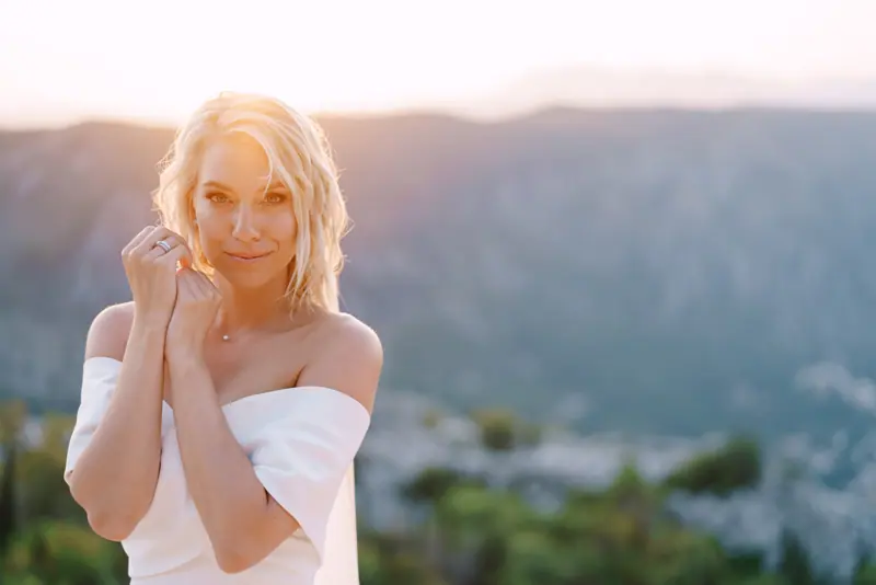 Woman in white dress with mountain view